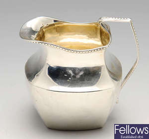 An Edwardian silver cream jug, etc.