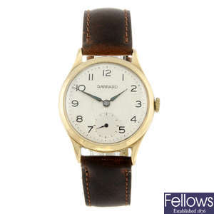 GARRARD - a mid-size 9ct yellow gold wrist watch.