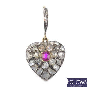 A late 19th century silver and gold ruby and diamond heart pendant.