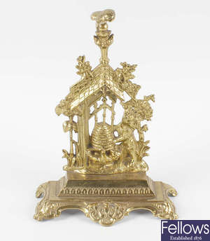 A Victorian brass pocket watch stand.