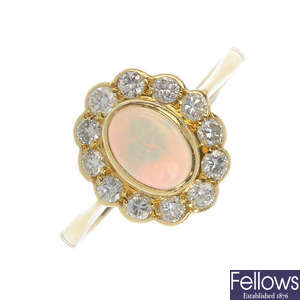 An 18ct gold oval opal and diamond ring.
