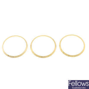 A group of three fluted bezels in the style of Rolex.