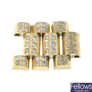 A group of yellow metal diamond set bracelet links in the style of Rolex. 