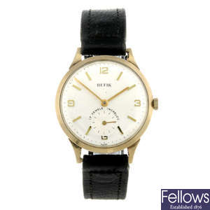 HEFIK - a gentleman's 9ct yellow gold wrist watch.