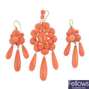 A coral earring and pendant set.