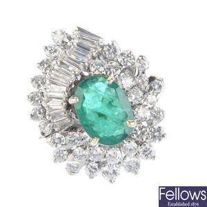 An emerald and diamond cluster ring. 