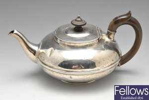 A George IV silver teapot, plus a cream jug and two bowls.
