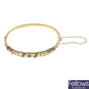 A late Victorian 15ct gold, paste and gem-set hinged bangle.