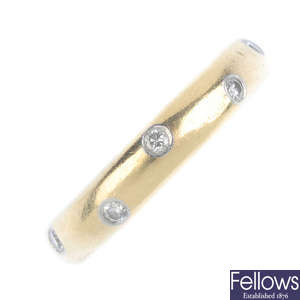 TIFFANY & CO. - an 18ct gold diamond band ring.