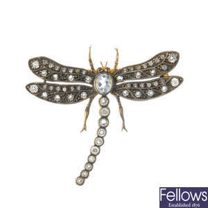 A topaz and diamond dragonfly brooch.