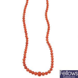 Two coral single-strand necklaces.