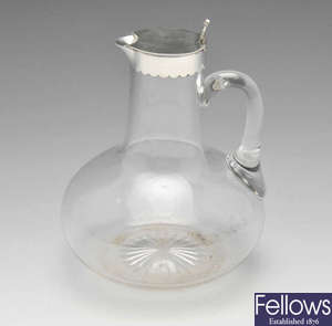 A late Victorian silver mounted clear glass claret jug.