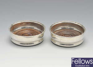 A pair of 1970's silver mounted bottle coasters.