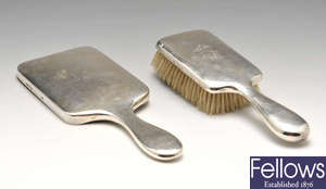 A late Victorian/Edwardian matched silver mounted hairbrush and hand mirror set, a silver condiment set plus another plated example and pair of candlesnuffers.