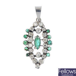 An emerald and diamond pendant.
