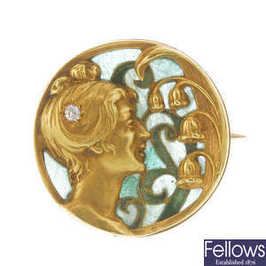 An Art Nouveau gold and enamel brooch.