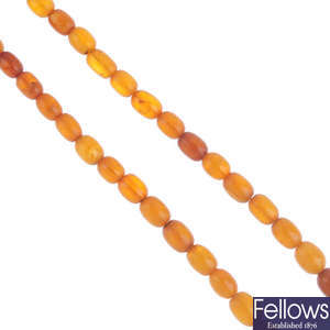 A natural amber bead necklace and some loose amber beads.