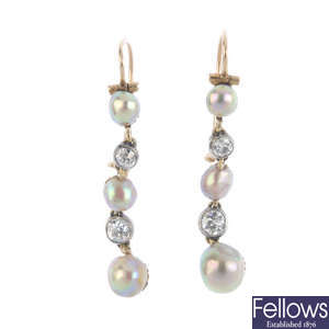 A pair of early 20th century pearl and diamond earrings.