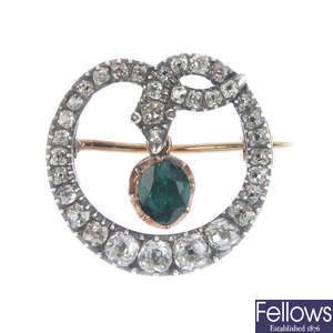 A mid Victorian gold and silver, emerald and diamond snake brooch.