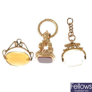 Two early 20th century gold swivel fobs and a carnelian fob.