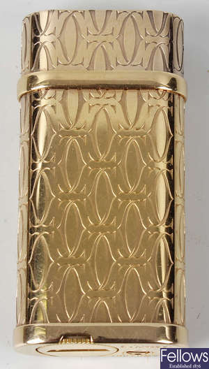 A gold plated Cartier lighter.