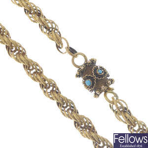 A fancy-link chain with turquoise clasp.