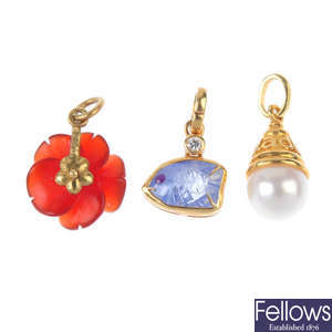 ADLER -  an 18ct gold diamond pendant and three gem-set charms.