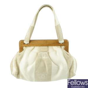 CHANEL - a white and beige canvas handbag.