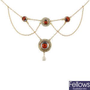 An early 20th century 9ct gold reverse carved intaglio ladybird necklace.