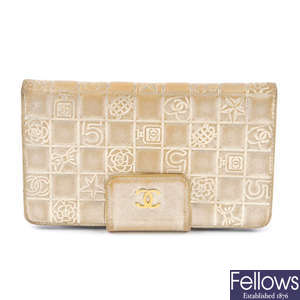 CHANEL - a gold embossed wallet.