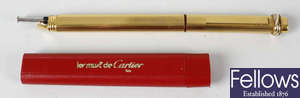 A gold plated Cartier ball point pen.