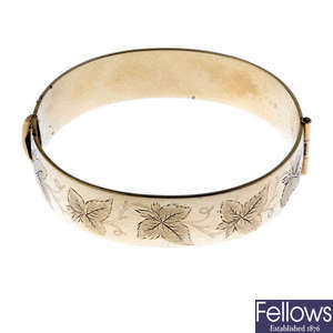Three rolled gold bangles.