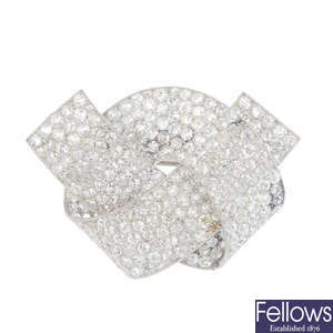 A diamond set bow brooch.