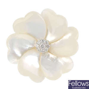 A mother-of-pearl and diamond flower brooch.