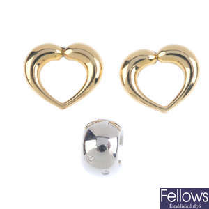 A single diamond hoop earring, and two hearts.