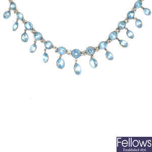 A blue zircon fringe necklace and an enamel and seed pearl brooch.