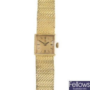OMEGA - a lady's 18ct gold wristwatch.