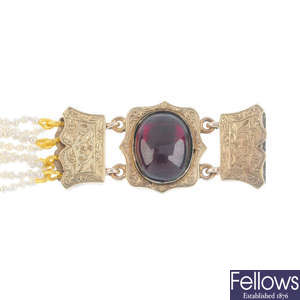 A late Victorian seed pearl eight-row bracelet, with gold garnet cabochon clasp.