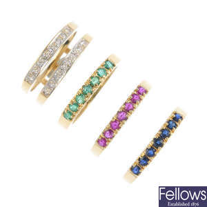 A set of four 18ct gold diamond and gem-set half-circle eternity rings.