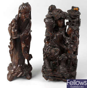 A box containing a carved hardwood oriental figure group, three similar rootwood figures, etc.