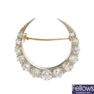 A late 19th century gold and silver diamond crescent brooch.