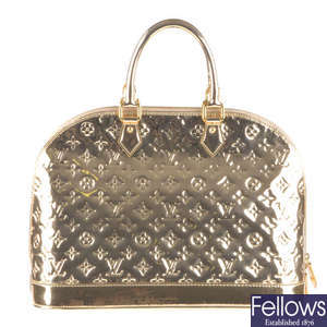 LOUIS VUITTON - a gold Monogram Miroir Alma MM handbag.
