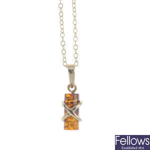 Two modified amber pendants, a chain and earrings.