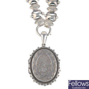 A late Victorian silver locket and chain.