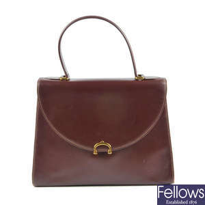CARTIER - a Bordeaux leather handbag.