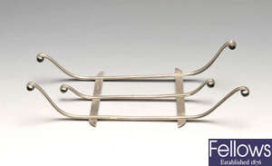 A nineteenth century silver stand, in the form of a sleigh or sledge.