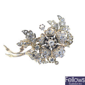 A diamond floral brooch.