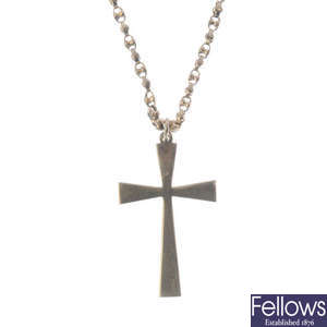 A cross pendant with chain and a pair of ear studs.