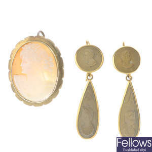 A pair of cameo earrings and a cameo brooch.