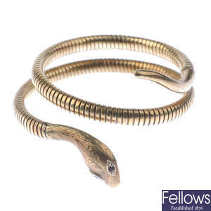 A 9ct gold 1970s coiled snake bangle.